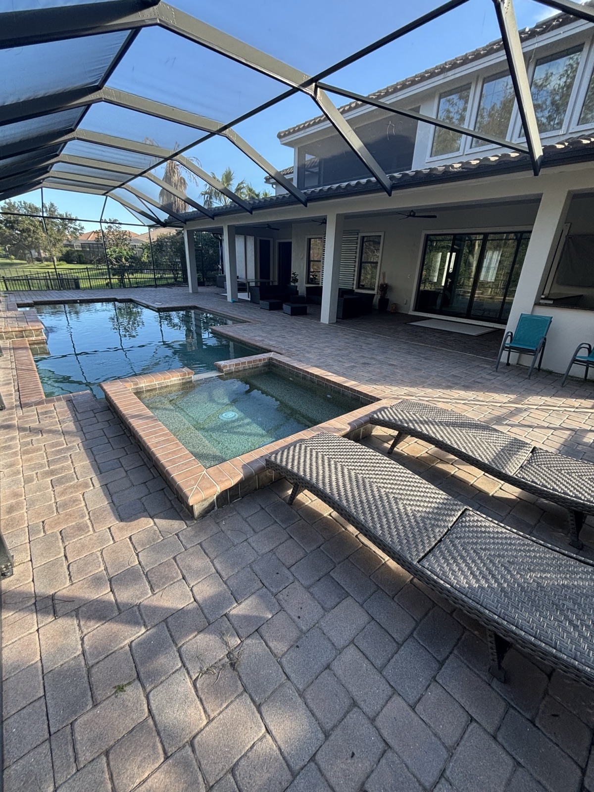 Aged builder-grade pavers on a Tampa pool deck before BayWave renovation